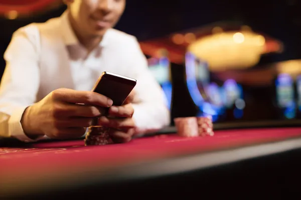 A young woman relaxing with her phone while dynamic casino elements float around her, illustrating the smooth mobile experience offered by the 786TT app.
