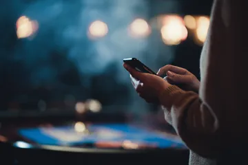 A glowing roulette wheel with cascading chips, symbolizing the engaging live and instant-win games available on 786TT.
